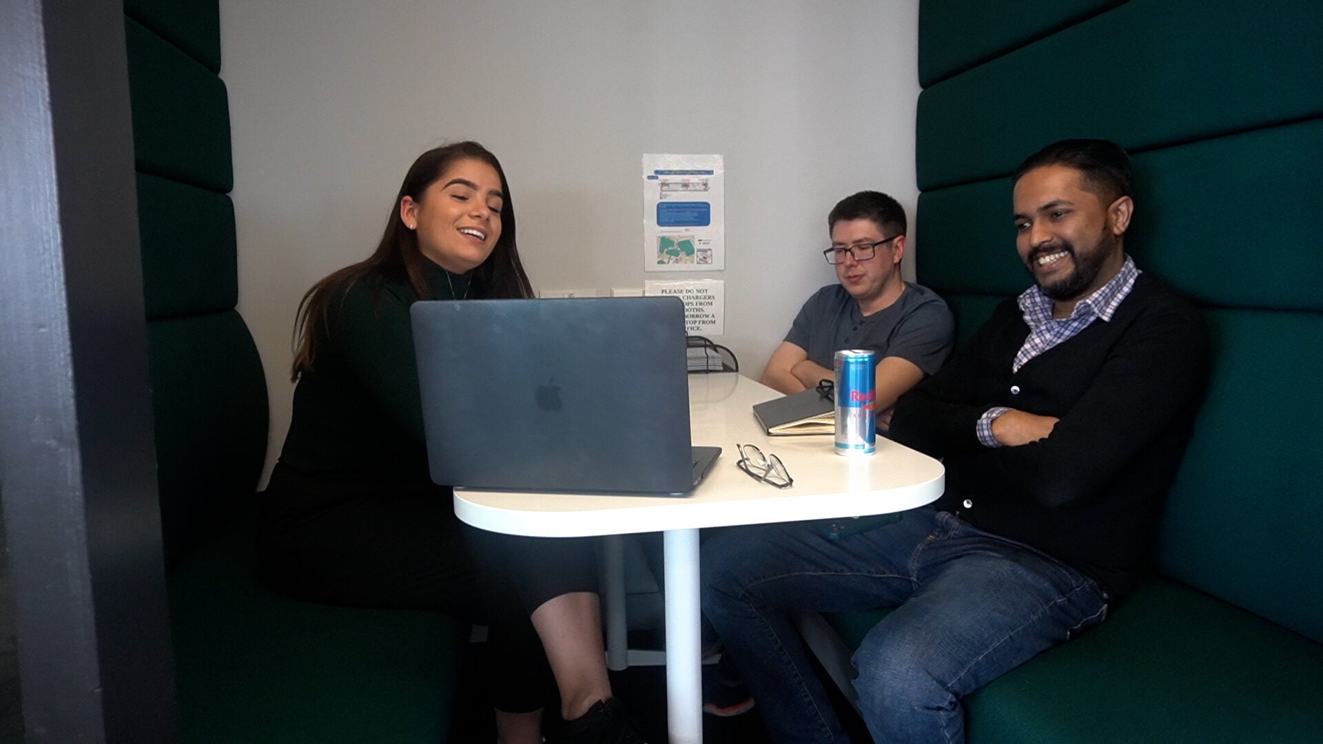 Legal and compliance team working in a meeting booth